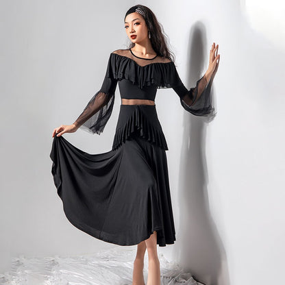 black ballroom dress with illusion neckline, waist insert, bell sleeves, and ruffle details