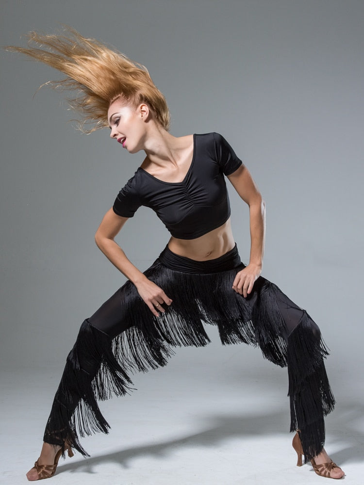 Black dance pants with layers of fringe and stirrup feet